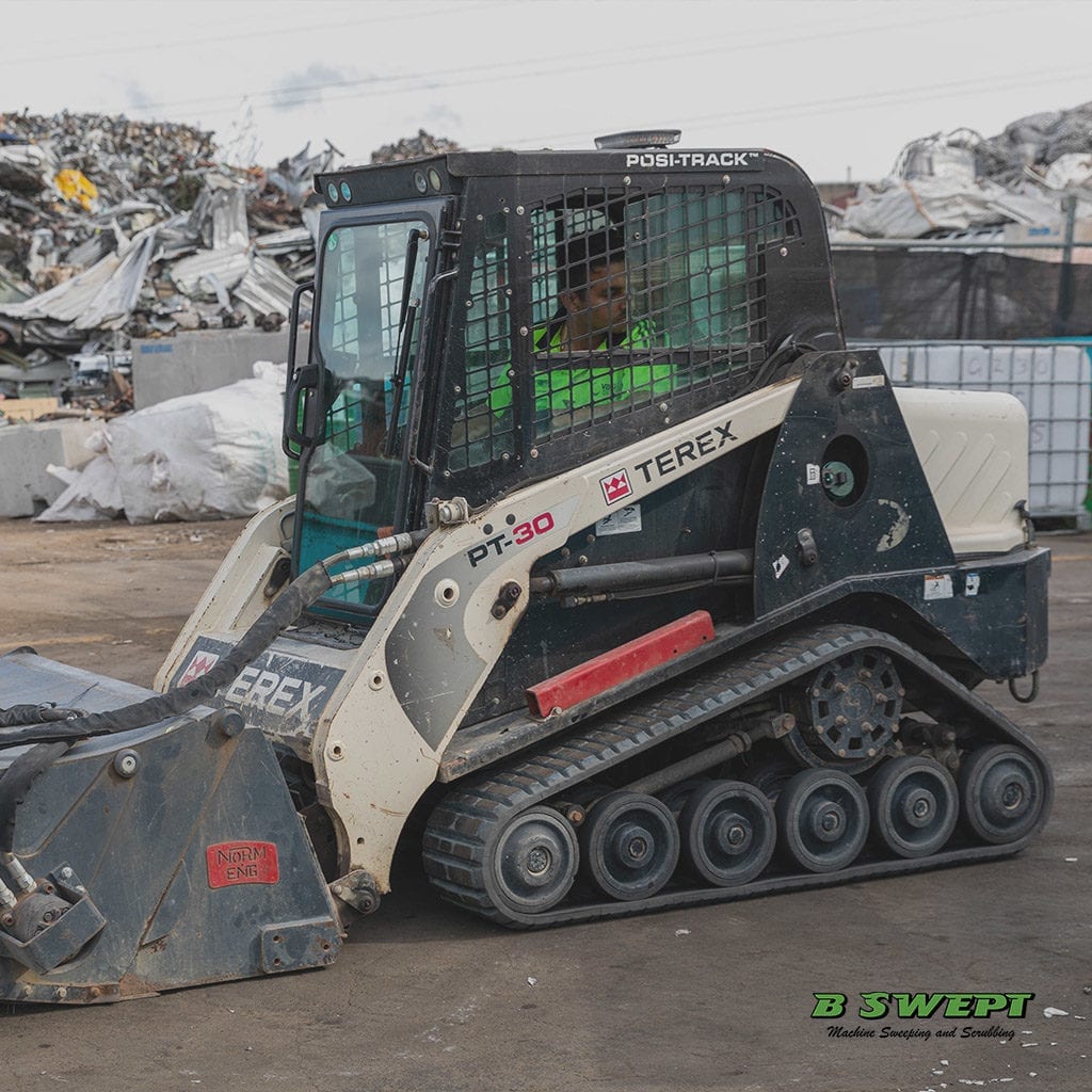 Bobcat sweeping in carpark